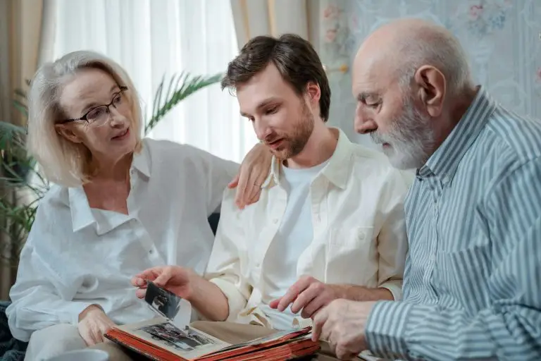 A younger man speaking to his older parents about downsizing.